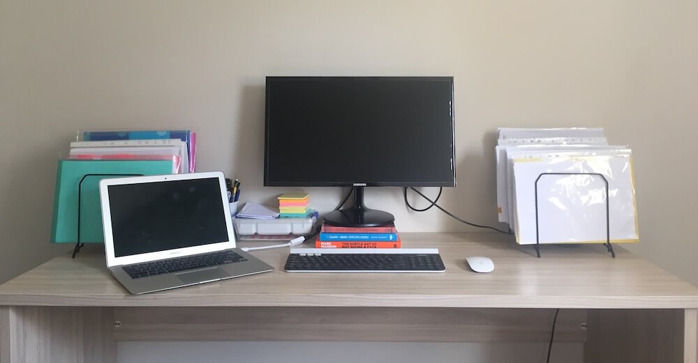 Home office desk without a monitor-arm and books as a riser